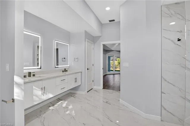 a view of a room with a large window and plants