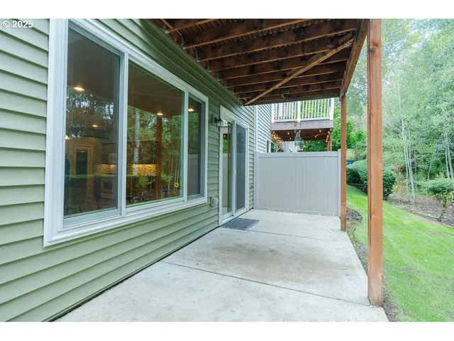 an aerial view of a house with a yard and outdoor seating