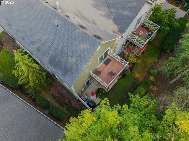 an aerial view of a house with a yard and large trees