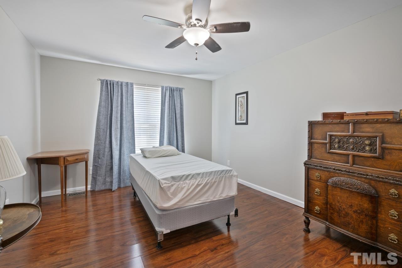 7020 Max Lane Raleigh, NC 27603 - Photo 14 of 16 a bedroom with a bed and a table
