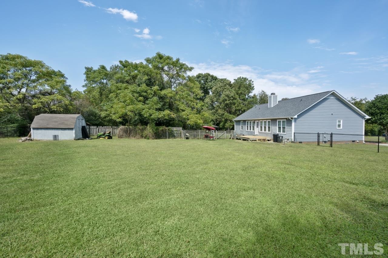 7020 Max Lane Raleigh, NC 27603 - Photo 3 of 16 a front view of a house with garden
