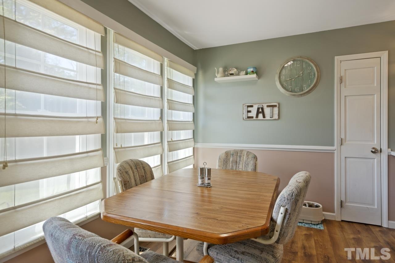 7020 Max Lane Raleigh, NC 27603 - Photo 8 of 16 a view of a dining room with furniture and wooden floor
