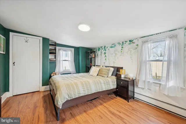 a bedroom with a large bed and a large window