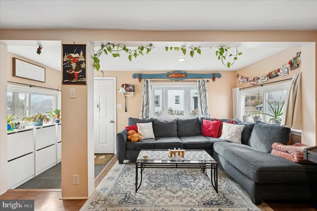 a living room with furniture and a painting on the wall