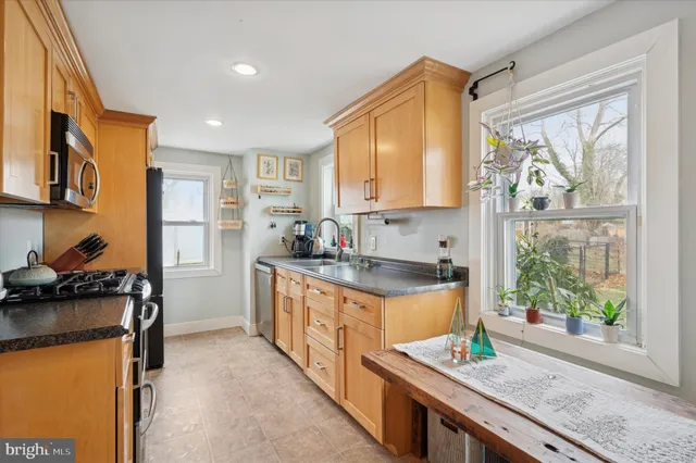 a kitchen with stainless steel appliances granite countertop a stove a sink and a refrigerator