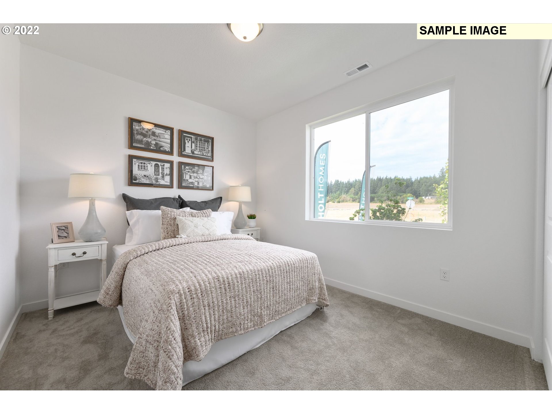 8847 North 5th Street, Unit LT61 Ridgefield, WA 98642 - Photo 30 of 31 a bedroom with a bed and a painting on the wall