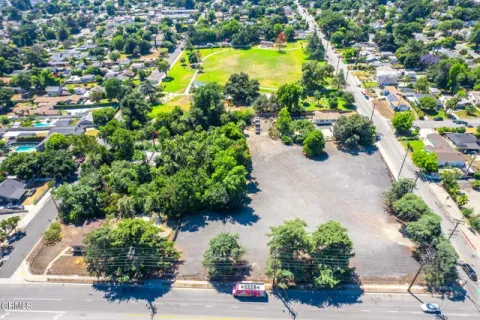 an aerial view of a houses with yard