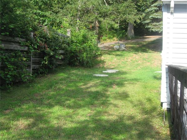 336 Mashapaug Road Holland, MA 01521 - Photo 5 of 17 a backyard of a house with lots of green space and lake view