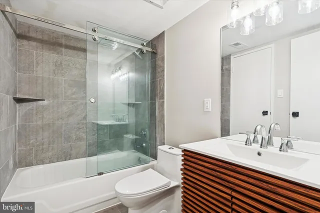 a bathroom with a sink a toilet and a bathtub