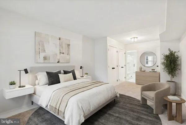 a bedroom with a bed a mirror and a lamp