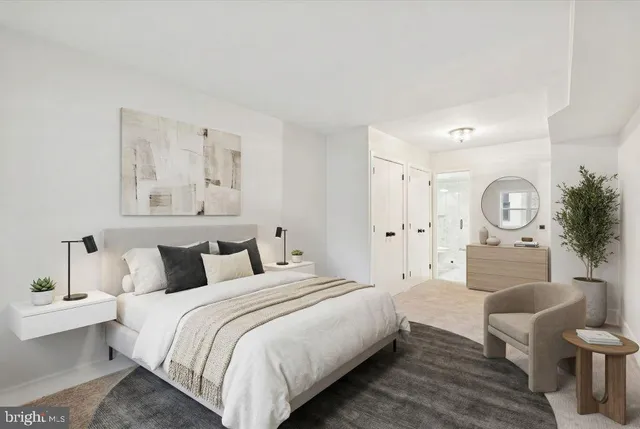 a bedroom with a bed a mirror and a lamp