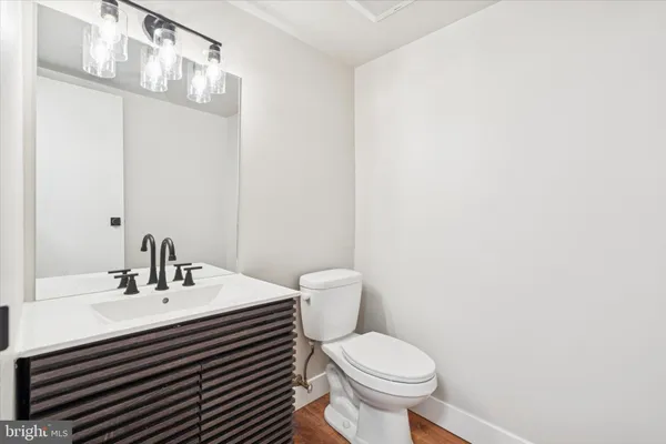 a bathroom with a sink a toilet and mirror