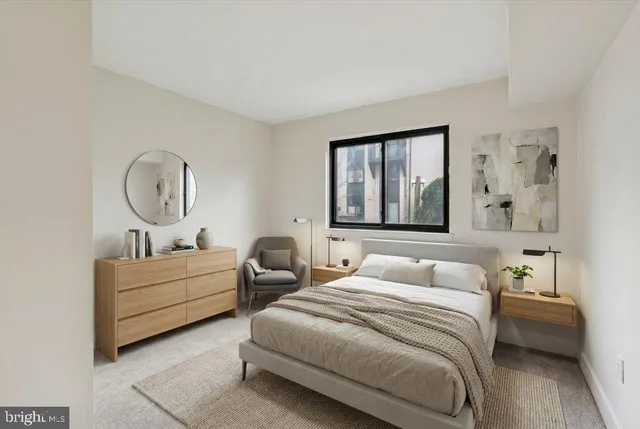 a bedroom with a bed a couch and dresser