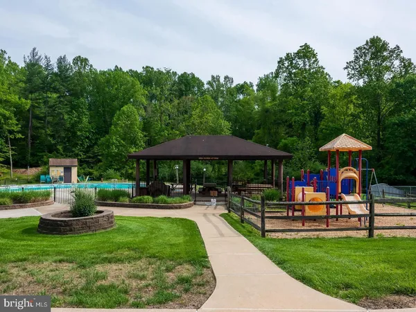 a view of a house with backyard sitting area and garden