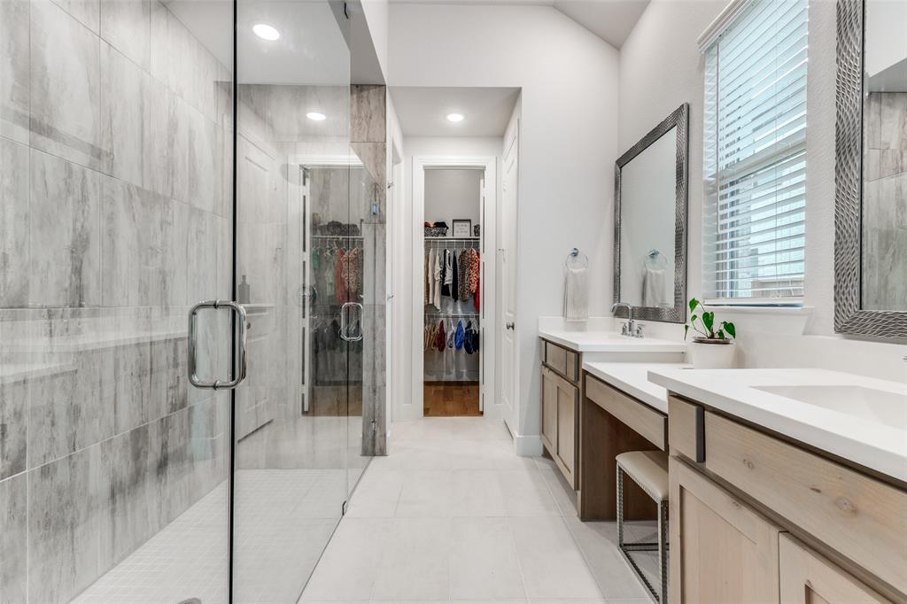 1835 Bell Court Van Alstyne, TX 75495 - Photo 5 of 39 Spa inspired bath featuring oversized walk in shower with dual shower heads, dual vanities, and makeup vanity