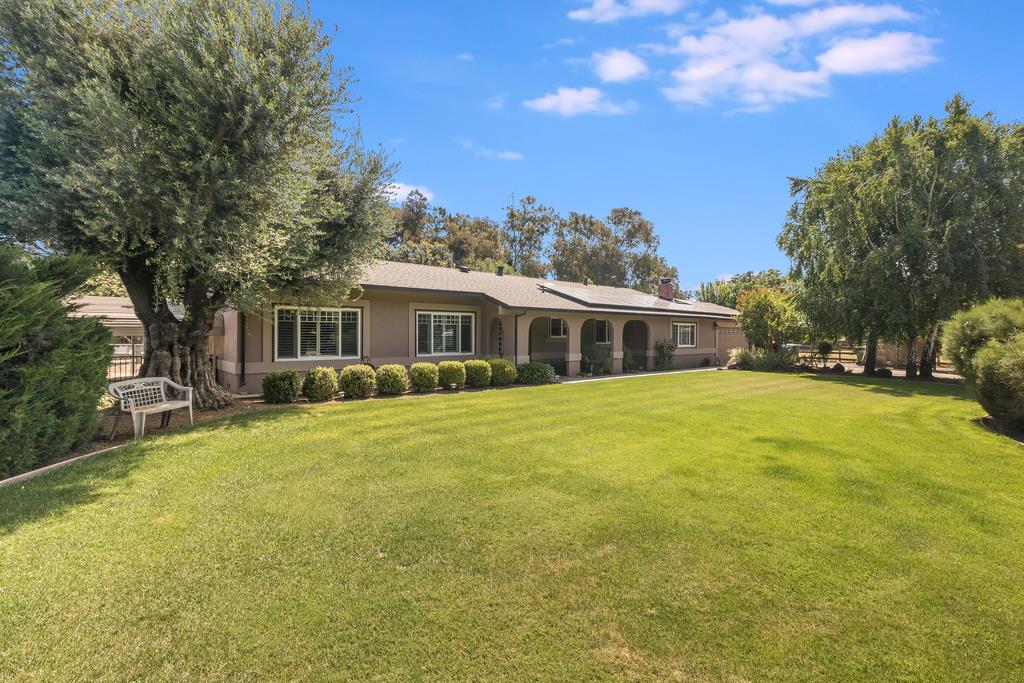 a front view of house with yard and trees