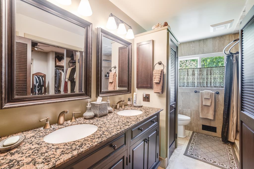 10640 La Corte Lane Gilroy, CA 95020 - Photo 13 of 29 a spacious bathroom with a granite countertop double vanity sink a mirror and a shower