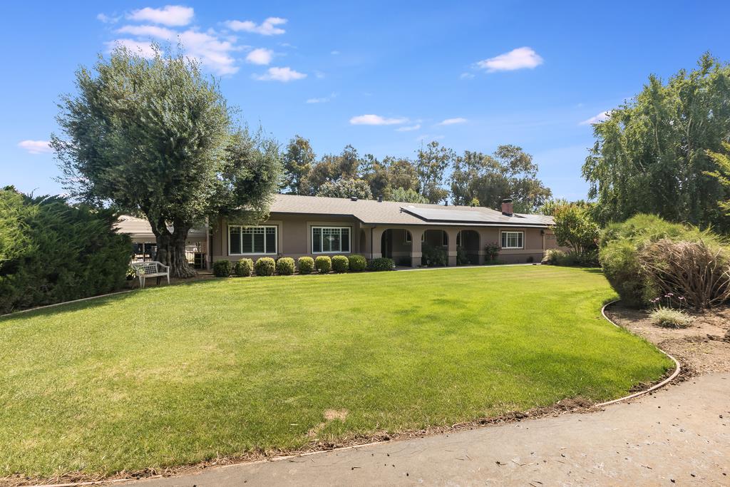 10640 La Corte Lane Gilroy, CA 95020 - Photo 2 of 29 a front view of house with yard swimming pool and trees in the background