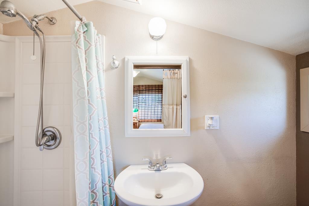 10640 La Corte Lane Gilroy, CA 95020 - Photo 27 of 29 a bathroom with a sink a mirror and a window