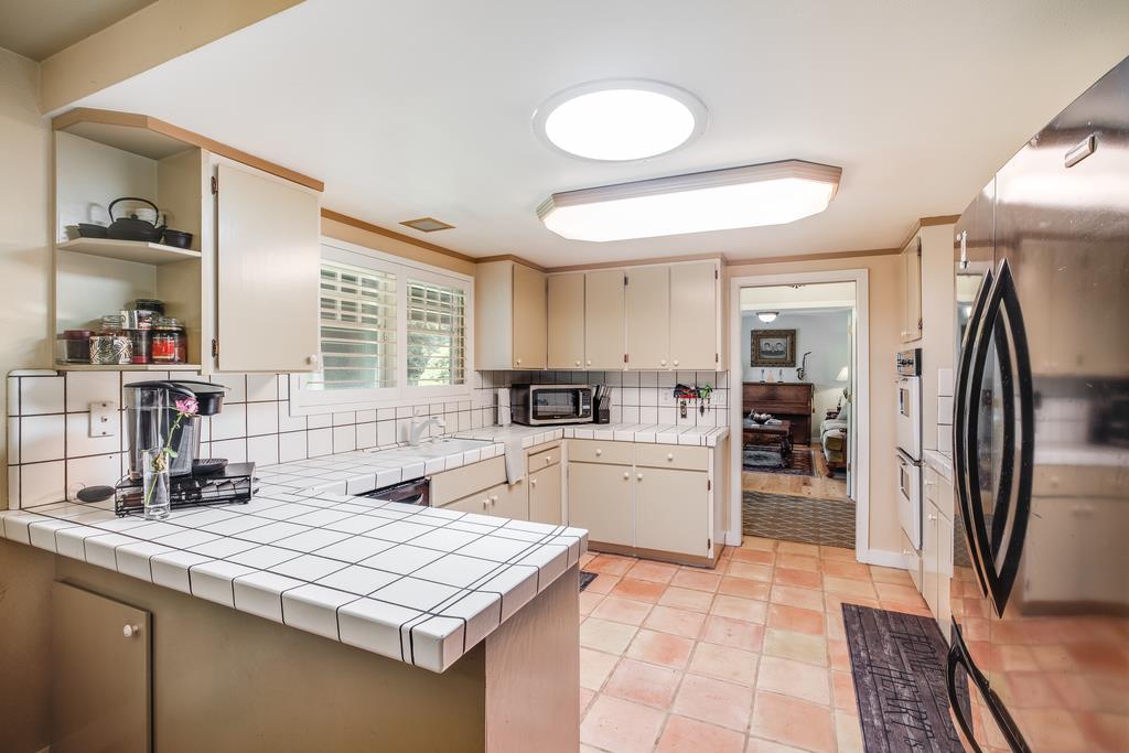 10640 La Corte Lane Gilroy, CA 95020 - Photo 6 of 29 a kitchen with stainless steel appliances granite countertop a refrigerator sink and stove