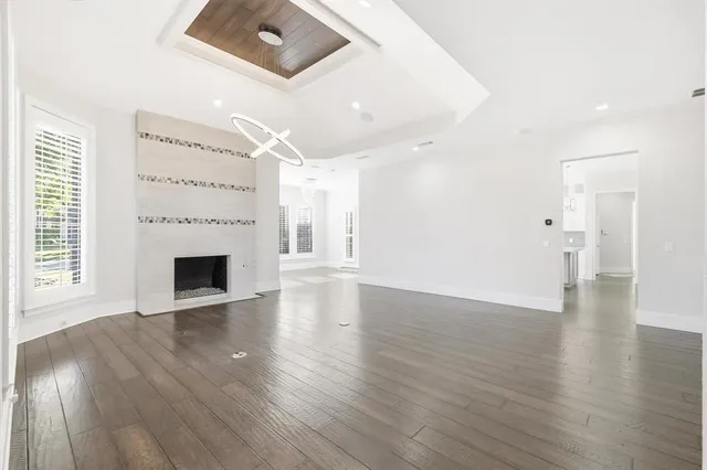a view of a livingroom with wooden floor and a fireplace