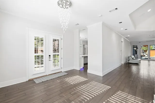 a view of a livingroom with wooden floor and a ceiling fan
