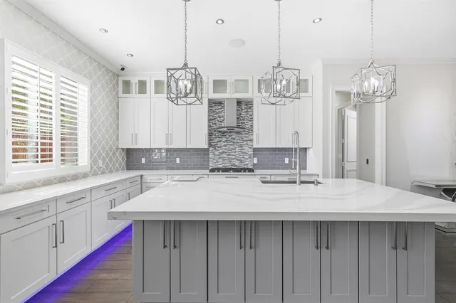 a kitchen with center island and large windows