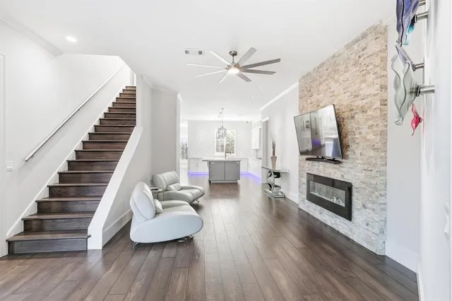 a living room with furniture fireplace and wooden floor