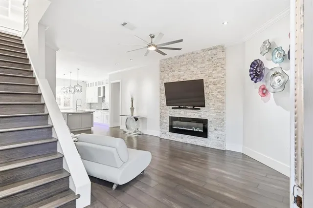 a living room with furniture a fireplace and a flat screen tv