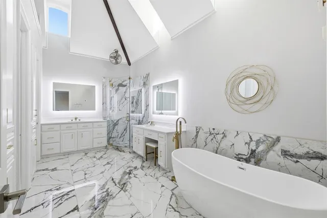 a bathroom with a bathtub sink and mirror