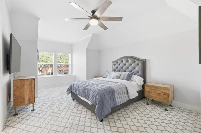 a bedroom with a bed and a television