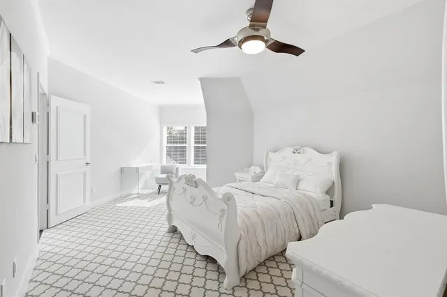 a large bedroom with bed and window