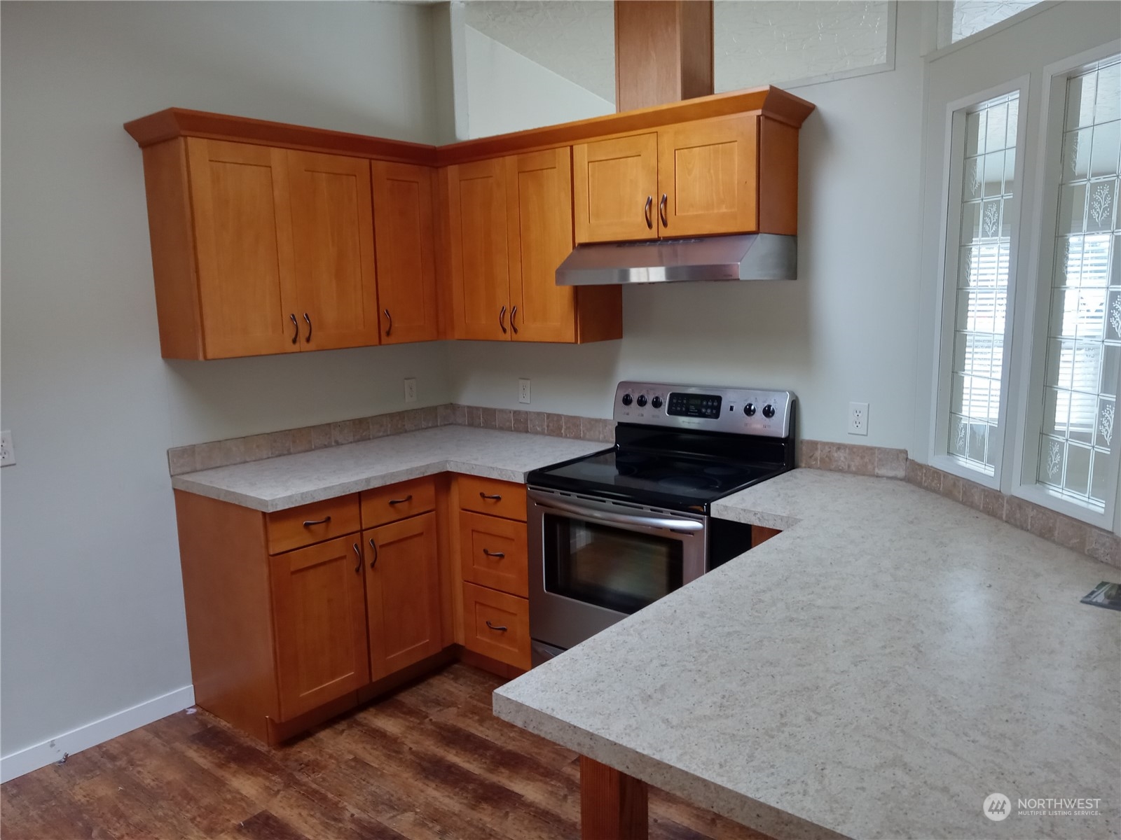 19721 Carper Road Southwest Rochester, WA 98579 - Photo 2 of 9 a kitchen with granite countertop a stove a sink and a microwave
