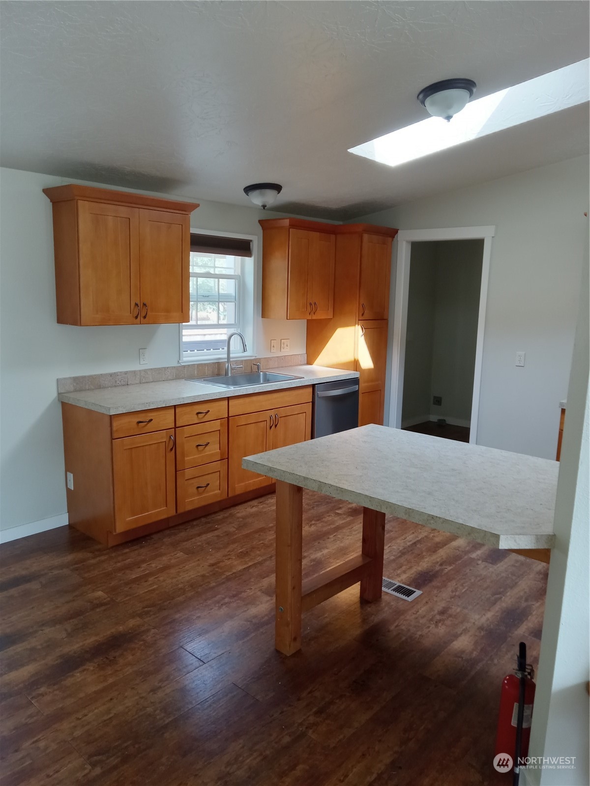 19721 Carper Road Southwest Rochester, WA 98579 - Photo 3 of 9 a kitchen with stainless steel appliances granite countertop a sink dishwasher and cabinets with wooden floor