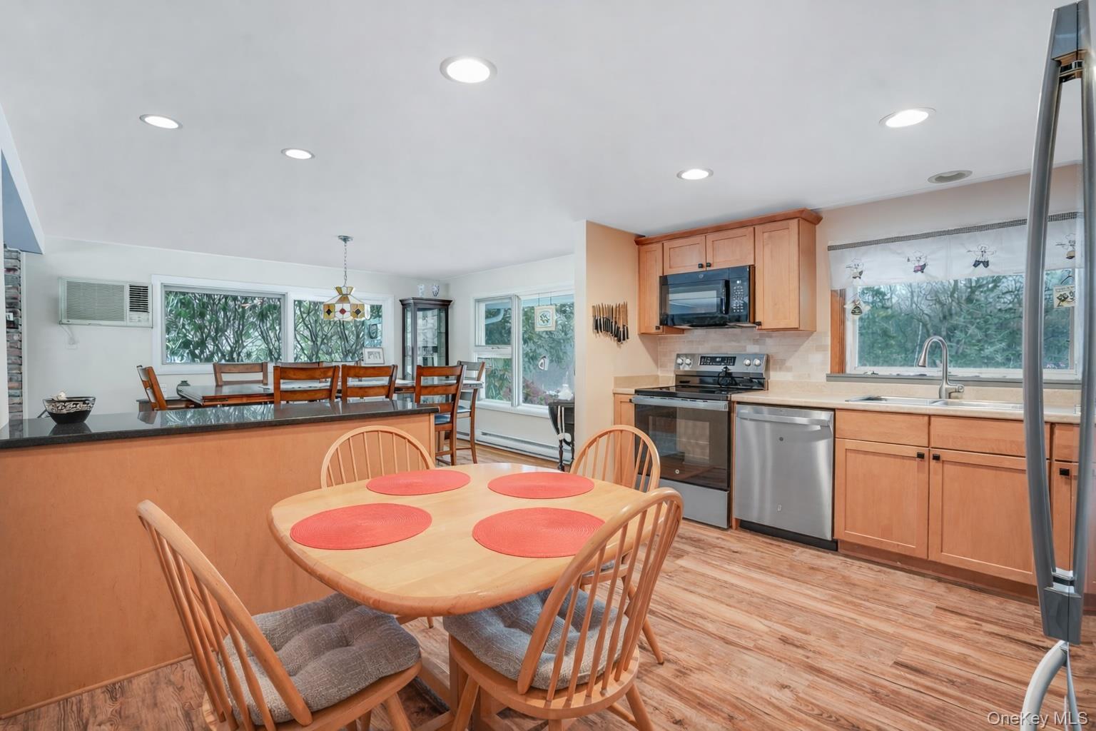 33 Milltown Road Brewster, NY 10509 - Photo 11 of 30 a kitchen with stainless steel appliances granite countertop a stove a sink a microwave a dining table and chairs