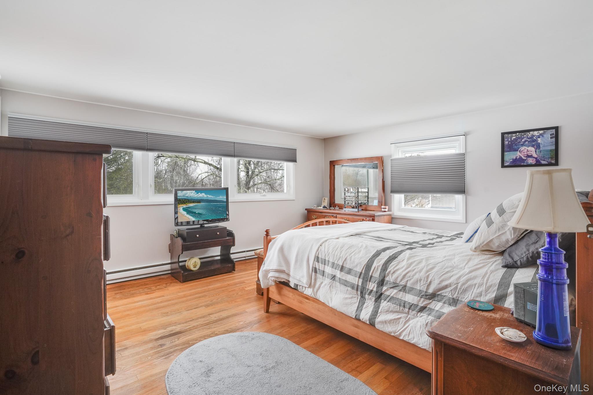 33 Milltown Road Brewster, NY 10509 - Photo 13 of 30 a bedroom with a bed and wooden floor