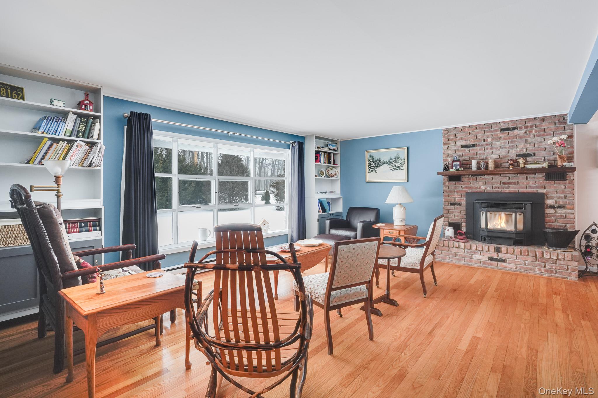 33 Milltown Road Brewster, NY 10509 - Photo 5 of 30 a dining room with furniture a fireplace and wooden floor