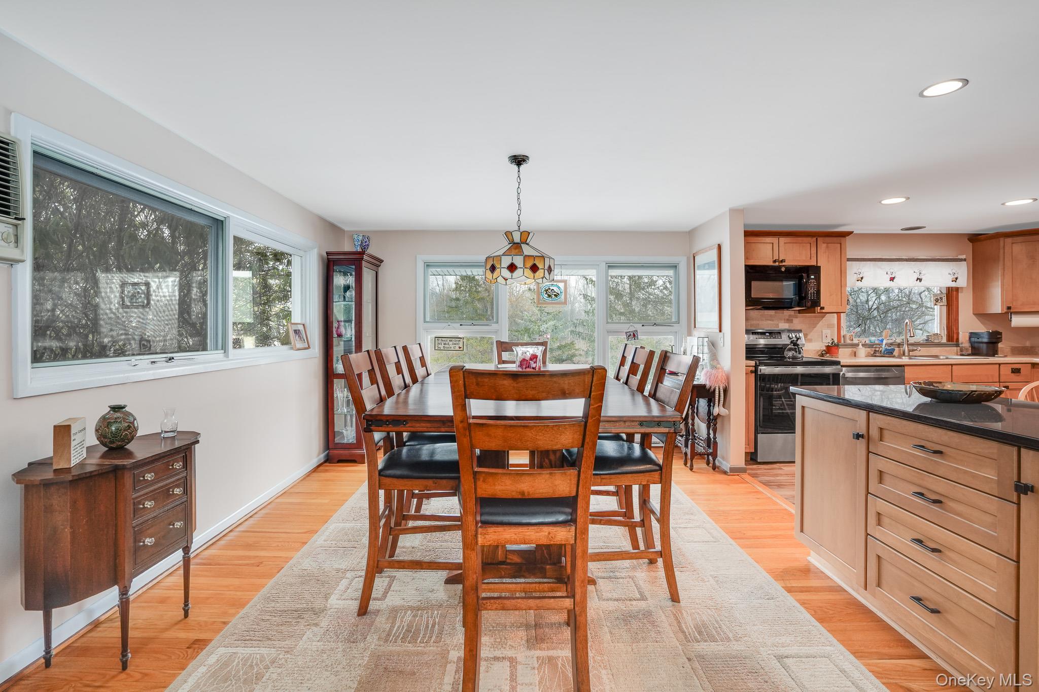 33 Milltown Road Brewster, NY 10509 - Photo 6 of 30 a dining room with wooden floor a glass table and chairs