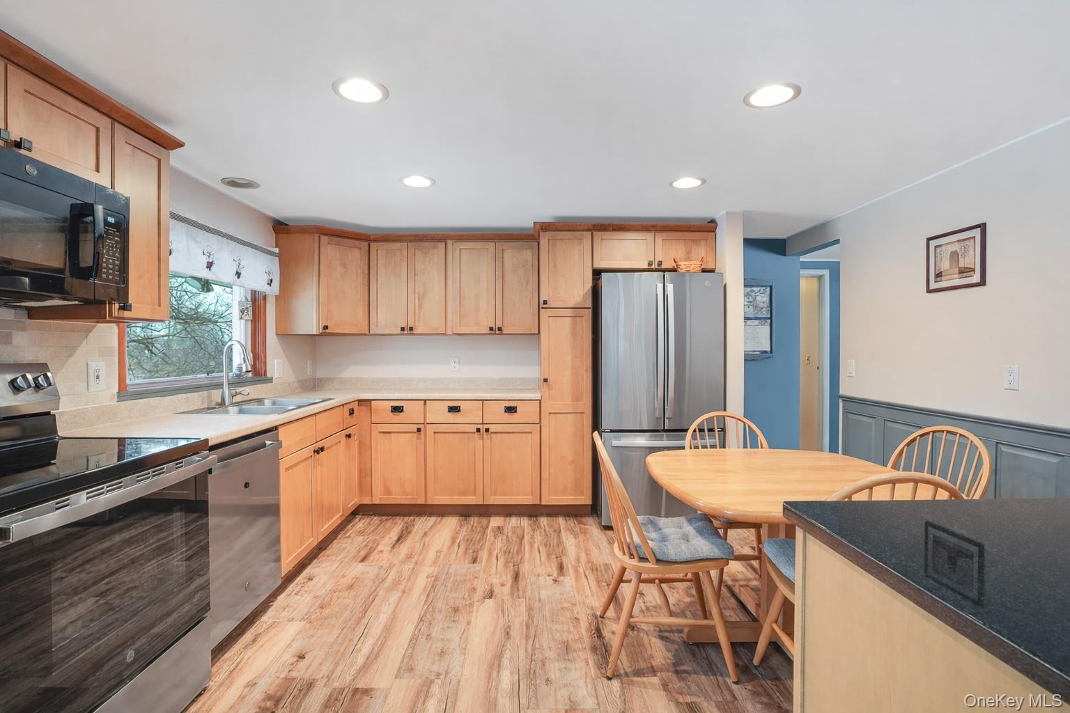 33 Milltown Road Brewster, NY 10509 - Photo 10 of 30 a open kitchen with stainless steel appliances granite countertop a refrigerator a sink dishwasher a dining table and chairs with wooden floor