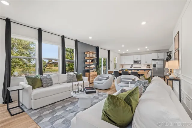 a living room with furniture and large windows