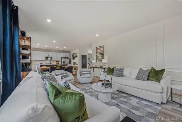 a living room with furniture kitchen view and a table