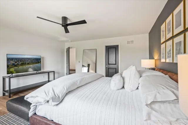 a bedroom with a bed and a painting on the wall