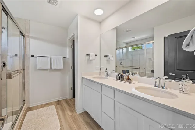 a bathroom with a double vanity sink mirror and
