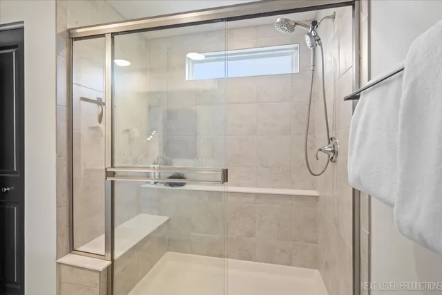a bathroom with a shower and a bath tub