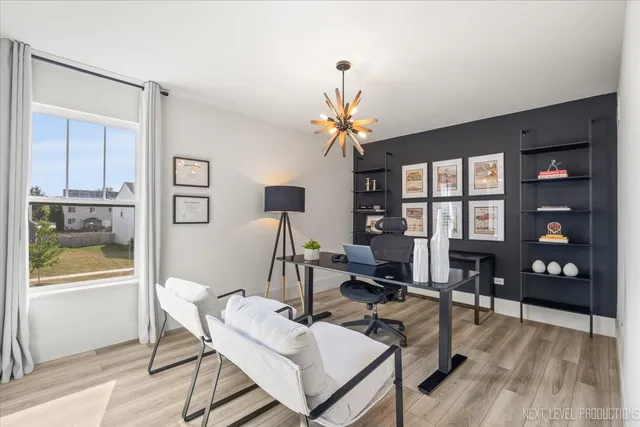 a living room with furniture a chandelier and a window