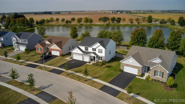 an aerial view of a house with a lake view