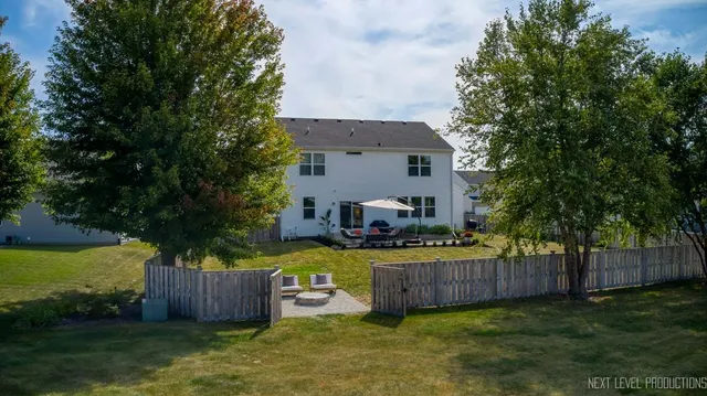 a view of a house with backyard and sitting area