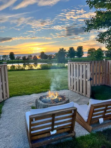 a view of a wooden deck with lake in front of it