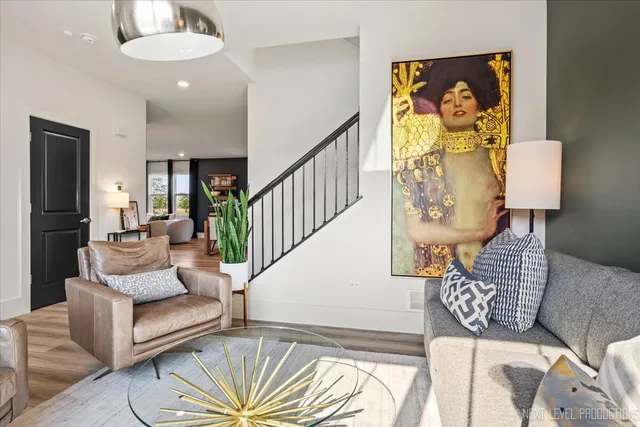 a living room with furniture and a chandelier
