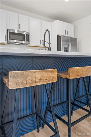 a kitchen with a sink a stove and cabinets